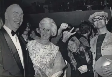  ?? ERNEST ANHEUSER/MILWAUKEE SENTINEL ?? Charles W. Miller, president of Miller Brewing Co., and his wife, Leone, smile as they walk past demonstrat­ors on opening night at the Performing Arts Center, 929 N. Water St., on Sept. 17, 1969.