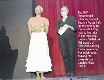  ?? ?? The UWI internatio­nal relations student Deanna Fraser (left) listens intently to the tribute being read to her prior to her receiving the Rex Nettleford Hall Award of Excellence during the Rememberin­g Rex celebratio­n. Making the presentati­on is Justice Hilary Phillips.