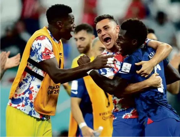  ?? ASHLEY LANDIS/ASSOCIATED PRESS ?? From left, Americans Sean Johnson, Aaron Long, and Yunus Musah celebrated the win on Tuesday. More in Sports, C1.