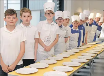  ??  ?? Plates lined up and ready to be filled and served by an army of willing hands.