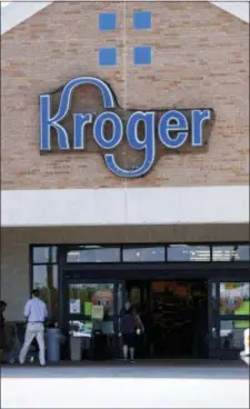  ?? ROGELIO V. SOLIS — THE ASSOCIATED PRESS ?? In this photo, a person exits a Kroger grocery store in Flowood, Miss. Kroger said Thursday, March 1, that it’s raising the minimum age to buy firearms and ammunition at all Fred Meyers stores to 21 years old, a day after Dick’s and Walmart announced...