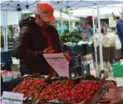  ?? MEGAN DOLSKI ?? Ignacio Ruiz sells fruit at the East York Farmers Market. A recent hailstorm affected the appearance of his produce.