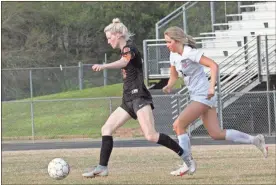  ?? Scott Herpst ?? Heritage’s Bailey Needham (right) give chase to LaFayette’s Bianca Rogers during Wednesday’s non-region clash at LaFayette.