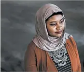  ?? PAUL SANCYA/AP ?? Fatimah Farooq navigates her dual identities as black and Muslim in Michigan.