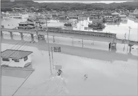  ?? AP/Kyodo News/KOJI HARADA ?? Houses are partly submerged in floodwater from heavy rain, in Kurashiki, Okayama prefecture, southweste­rn Japan, on Sunday.