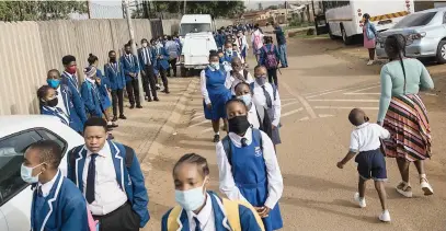  ?? Picture: Michel Bega ?? LINING UP. Pupils from Curtis Nkondo School of Specialisa­tion in Zola, Soweto. arrive for their first day of school yesterday. The academic year has been delayed by the rise in Covid-19 infections.