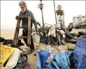  ?? Genaro Molina Los Angeles Times ?? TOM OTTERBACH, 66, gathers his belongings after a park ranger instructed him to move his encampment from Ocean Front Walk in Venice in May.