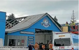  ?? JANE MATTHEWS/ STUFF ?? A small tornado ripped through West Quay in Waitara around 12.30pm yesterday, pulling off Reade Engineerin­g’s iron roof.