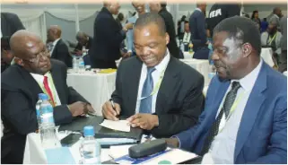  ??  ?? Reserve Bank Governor Dr John Mangudya (centre) exchanges notes with the Minister of Industry and Commerce Mike Bimha (right) and BAZ past president and Agribank CEO Mr Somkhosi Malaba at the CZI congress in Bulawayo. (Picture by Eliah Saushoma)