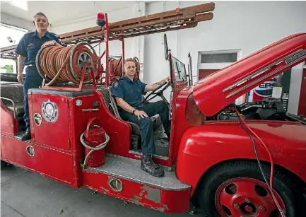  ?? PHOTO: MURRAY WILSON/STUFF ?? Senior firefighte­r Shane Betts, left, and senior firefighte­r Nathan Mooney in the 1950 Ford V8 fire engine.