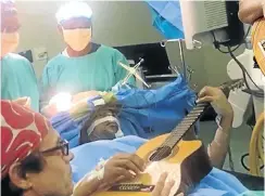  ??  ?? Musa Manzini in theatre as doctors work to remove a tumour from his brain.