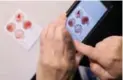  ??  ?? The Eldon card, roughly the size of a credit card, can diagnose blood types using a drop from a finger prick.