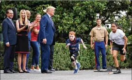  ?? OLIVIER DOULIERY / ABACA PRESS ?? President Donald Trump, with daughter Ivanka Trump (left, clapping), watches kids participat­e in races during the White House Sports and Fitness Day on the South Lawn on Wednesday in Washington.