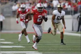  ?? JAY LAPRETE — THE ASSOCIATED PRESS ?? Ohio State running back J.K. Dobbins gets into the open field for a large gain against Army in Columbus.