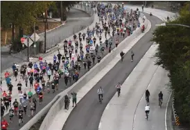  ?? PHOTO BY ANDY HOLZMAN ?? The 110Freeway is closed to vehicular traffic Sunday morning for ArroyoFest, an openstreet­s event along Los Angeles' original freeway. A Run the 110race was also held.