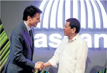  ?? MARK R. CRISTINO/GETTY IMAGES ?? Prime Minister Justin Trudeau shakes hands with Philippine President Rodrigo Duterte, right, before the opening ceremony of the 31st Associatio­n of Southeast Asian Nations (ASEAN) Summit in Manila on Monday.