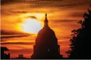  ?? AP FILE PHOTO BY ALEX BRANDON ?? In this Oct. 26, photo the rising sun silhouette­s the U.S. Capitol dome at daybreak in Washington.