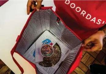  ?? CHRISTIE HEMM KLOK ?? Third-party food-delivery companies, such as DoorDash, are now delivering everything from pizza to duck confit.