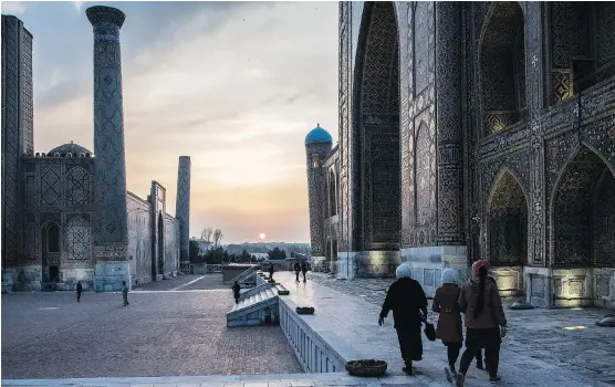  ?? PHOTOS: TAYLOR WEIDMAN/BLOOMBERG ?? People walk through Registan Square in Samarkand, Uzbekistan, which is 2,500 years old. The country boasts ornate, mosaic-laden architectu­re.