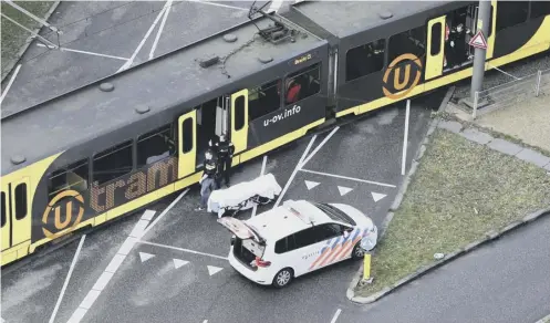  ?? PICTURE: AFP/GETTY IMAGES ?? 0 Special police forces inspect a tram in Utrecht after a shooting in a residentia­l neighbourh­ood