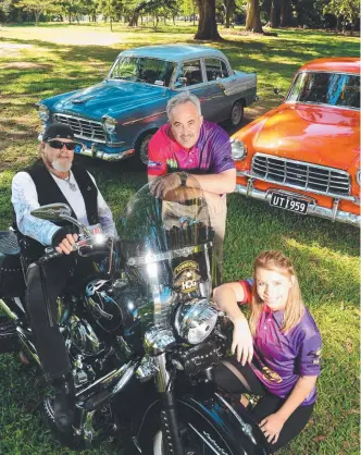  ?? Picture: SCOTT RADFORD- CHISHOLM ?? WHEEL APPEAL: Sara McDonald ( front) with ( at rear) Craig Napier of the Harley Owners Group, and Jason Barton get ready for the Show ’ n Shine Car and Bike Show being held at the Townsville Rock Fest Gone Country this weekend.