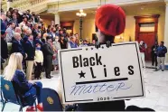  ?? BRYNN ANDERSON/ASSOCIATED PRESS ?? A supporter wears a “Black Lies Matter” sign as Georgia Gov. Brian Kemp speaks during a news conference at the State Capitol on Saturday in Atlanta.
