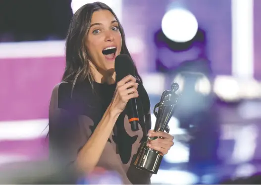  ?? NATHAN DENETTE/THE CANADIAN PRESS ?? Charlotte Cardin celebrates with her Juno for album of the year at the awards in Toronto on Sunday. The Montreal singer landed four prizes in total.