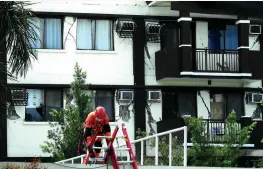  ?? 31/ BING GONZALES ?? A RESCUER gets into the premises of the Ecoland 4000 residences following the 6.5 magnitude earthquake with epicenter in Tulunan, North Cotabato, on Oct.