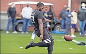  ?? AP-Brynn Anderson, File ?? In this March 16 file photo, Georgia Tech punter Pressley Harvin III punts the ball during the school’s Pro Day football workout for NFL scouts in Atlanta. NFL scouts who gathered for Georgia Tech’s pro day didn’t just want to see 263-pound punter Pressley Harvin boot the ball a mile. They also asked him to throw some passes, and he dazzled them with his arm, too.