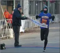  ?? BY JOE BOYLE JBOYLE@DIGITALFIR­STMEDIA.COM @BOYLERALER­TTROY ON TWITTER ?? Ryan Udvadia finishes the 10k and is the first to cross the finish line on November 22for the 71st annual Troy Turkey Trot.