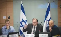  ?? (Yonatan Sindel/Flash90) ?? RELIGIOUS ZIONIST PARTY MK Simcha Rothman (center) leads a vote at the Knesset yesterday.