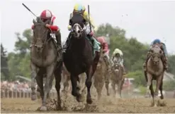  ??  ?? BALTIMORE: Cloud Computing #2 ridden by Javier Castellano (L) beats Classic Empire #5 ridden by Julien Leparoux to win the 142nd running of the Preakness Stakes at Pimlico Race Course. —AFP