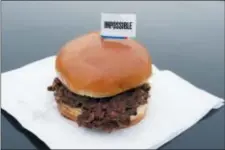  ?? NATI HARNIK — THE ASSOCIATED PRESS ?? The Impossible Burger, a plant-based burger containing wheat protein, coconut oil and potato protein among it’s ingredient­s, is seen Friday.