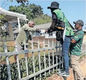  ?? | Supplied. ?? A CHATSWORTH resident accepts a MKP T-shirt during the party’s election campaign.