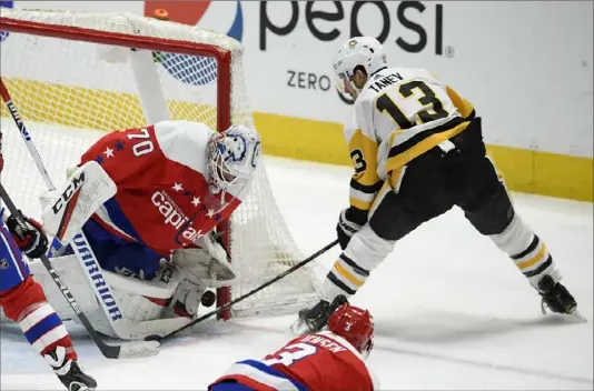  ?? Associated Press ?? Capitals goaltender Braden Holtby stops a shot from the Penguins’ Brandon Tanev in the third period Sunday in Washington.