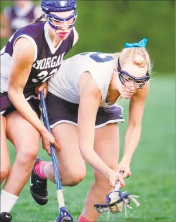  ?? Hearst Connecticu­t Media file photo ?? During this May 2010 match, Haddam-Killingwor­th High school lacrosse captain Camille Kostek wins possession of a loose ball against Morgan High School’s Mackenzie Taylor during a home game.