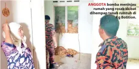  ??  ?? ANGGOTA bomba meninjau rumah yang rosak akibat dihempap tanah rumtuh di Kg Botition.