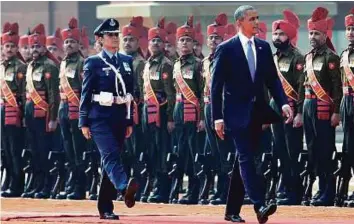  ?? AP ?? President Barack Obama reviews members of the military during an arrival ceremony at Rashtrapat­i Bhavan, the presidenti­al palace, in New Delhi on January 25, 2015. Wing Commander Pooja Thakur led the guard of honour during Obama’s visit to India last...