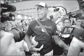  ?? AP/MARK SCHIEFELBE­IN ?? Former NBA player Dennis Rodman arrives at Beijing Capital Internatio­nal Airport on Saturday after a flight from Pyongyang, North Korea.