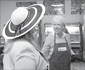  ?? Nick Koon/Orange County Register/TNS) ?? Laguna Beach Food Pantry volunteer Marianna Hof helps a visitor shop for food on Aug. 11 in Laguna Beach, Calif. Hof, a retired librarian, volunteers six days a week at the pantry.