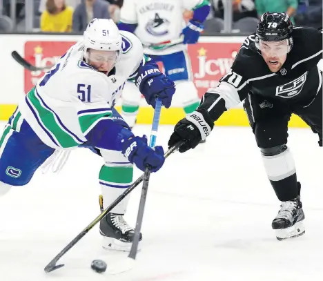  ?? JEFF SWINGER/THE ASSOCIATED PRESS ?? Canucks defenceman Troy Stecher and Kings forward Tanner Pearson battle for the puck during a pre-season game on Monday in Salt Lake City, Utah. The Kings won 4-1. Stecher showed flashes of offensive flair during the game, leading several rushes.