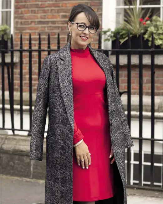  ??  ?? Suzanne wears Cath Kidston 01 frames, €189 from Specsavers; earrings, €99, Pandora; coat, €175, dress, €54, both M&S