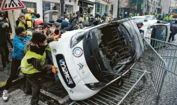  ?? Foto: Lucas Barioulet, afp ?? In Paris blieb es nicht beim friedliche­n Protest. Anhänger der Bewegung der „Gelben Westen“warfen Autos um, errichtete­n Barrikaden und legten Feuer.