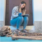  ?? MANU FERNANDEZ THE ASSOCIATED PRESS ?? Flavia Teixeira works after an exhumation inside a mass grave in Guadalajar­a, Spain, in October.