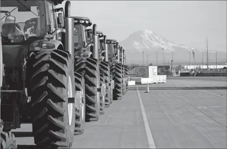  ?? ASSOCIATED PRESS FILE PHOTO] ?? In this Nov. 4, 2019, photo, John Deere tractors made by Deere & Company are shown as they are readied for export to Asia at the Port of Tacoma in Tacoma, Wash. The U.S. trade deficit fell in September 2020 after hitting a 14-year high in August as exports outpaced imports. [TED S. WARREN/