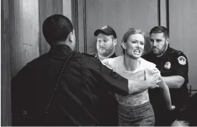  ?? Erin Schaff / New York Times ?? A protester is escorted out by Capitol Police during Wednesday’s confirmati­on hearing for Judge Brett Kavanaugh on Capitol Hill.