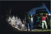  ?? MOSA’AB ELSHAMY — THE ASSOCIATED PRESS ?? Smugglers lift onto a vehicle a fishing boat in a remote desert out of the town of Dakhla in Morocco-administer­ed Western Sahara on Dec. 22. The boat is intended to be used to transport migrants to the Canary Islands.