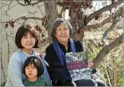  ?? ?? Kathy Masaoka poses with her daughter, Mayumi, and her grandson, Yuma, outside her home in Los Angeles.