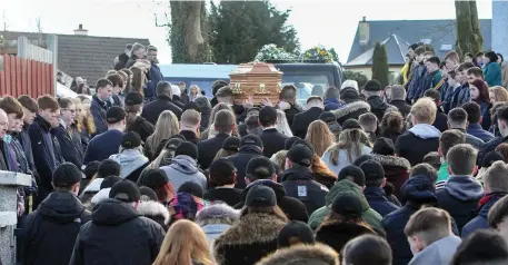  ??  ?? Mourners follow the coffin carrying the remains of Jimmy Loughlin after leaving St Therese’s Church, Ballintogh­er.