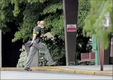  ?? Matt Freed/ Post- Gazette ?? An FBI agent heads into Brighton Rehabilita­tion and Wellness Center on Thursday in Beaver.